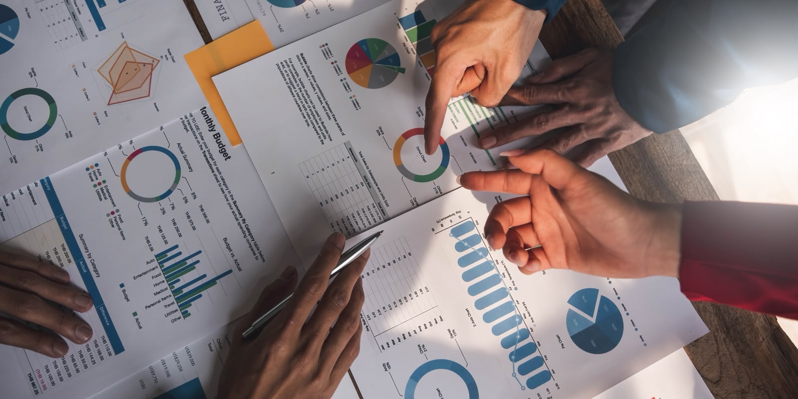Team reviewing budget charts and operational reports during a planning meeting