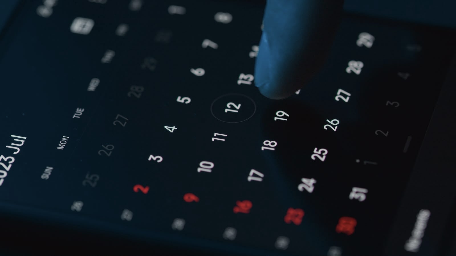 Hand scheduling an appointment on a smartphone calendar app