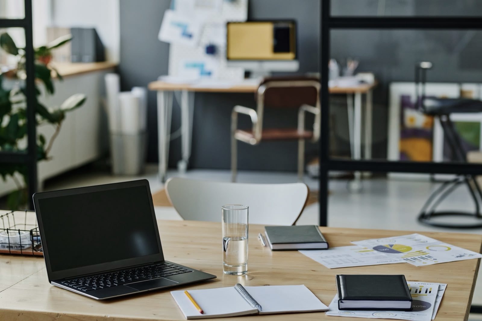 Modern executive workspace with laptop, documents, and operational charts on a desk