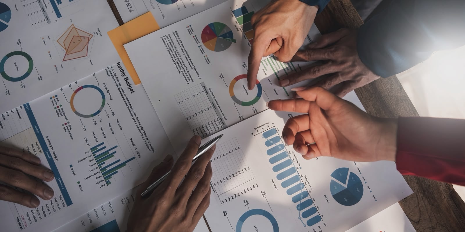 Team reviewing charts and budget documents together at a meeting table