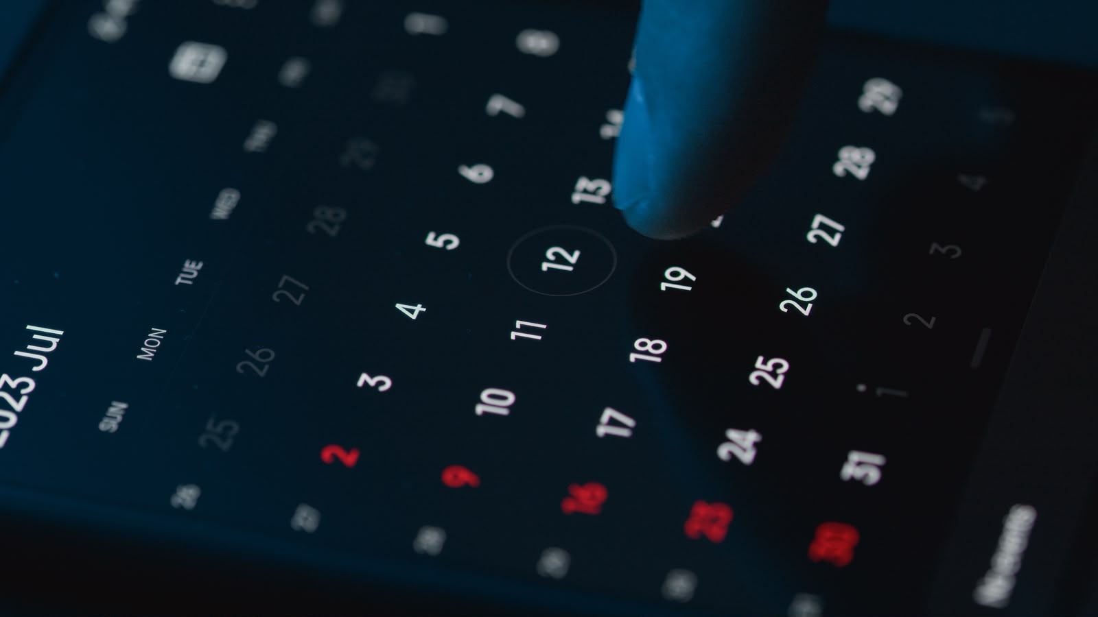 Hand selecting an appointment date on a smartphone calendar app