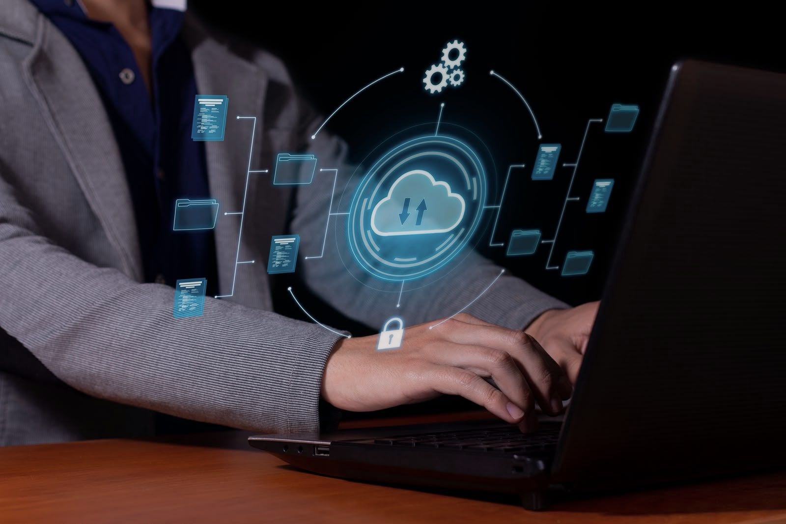 Professional working on a laptop with cloud computing and data security graphics